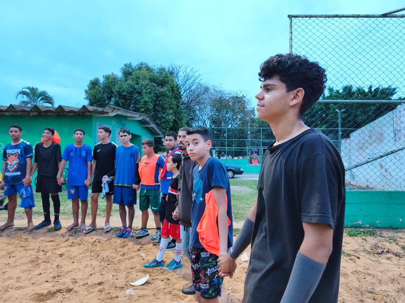 Jovens de mãos dadas na oração da União antes do treino